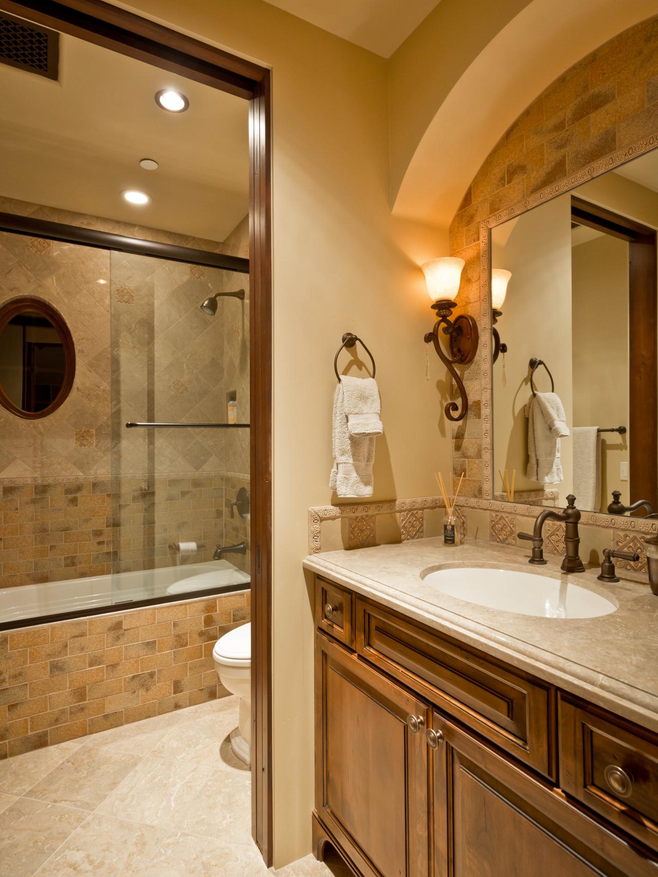 Mediterranean Bathroom with Tilework and Arch Over Vanity