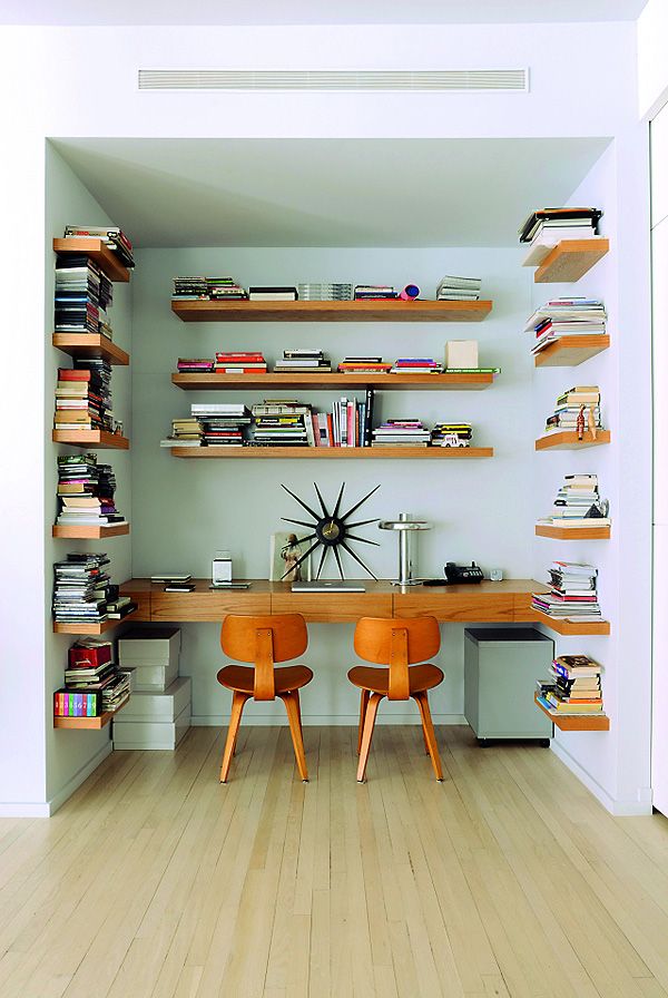 The shelves in the office space are custom made perfectly matching the two Eames chairs below.