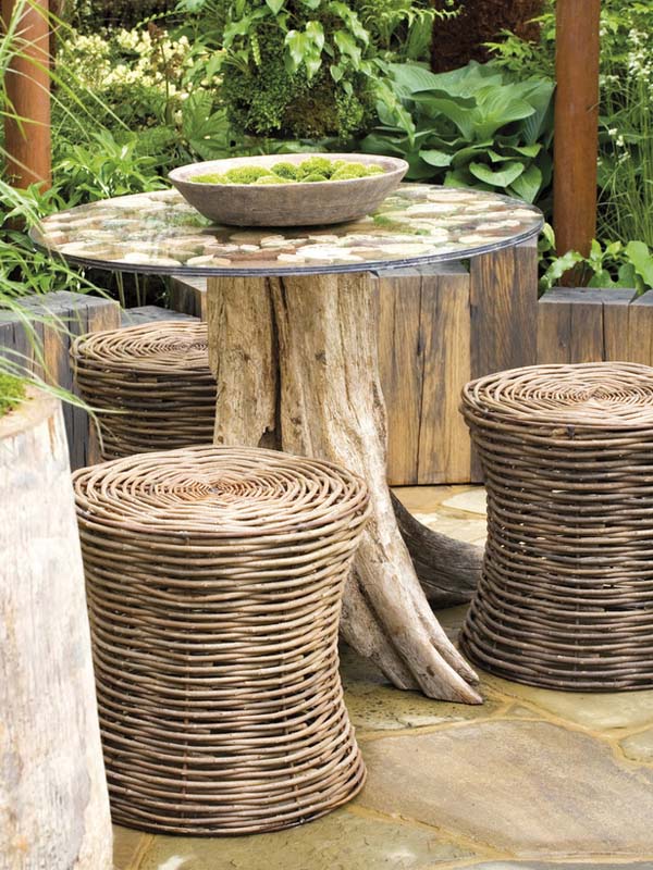 Wicker chairs and small tree trunk table in patio garden, Chelsea Flower Show 2006, The Green Room