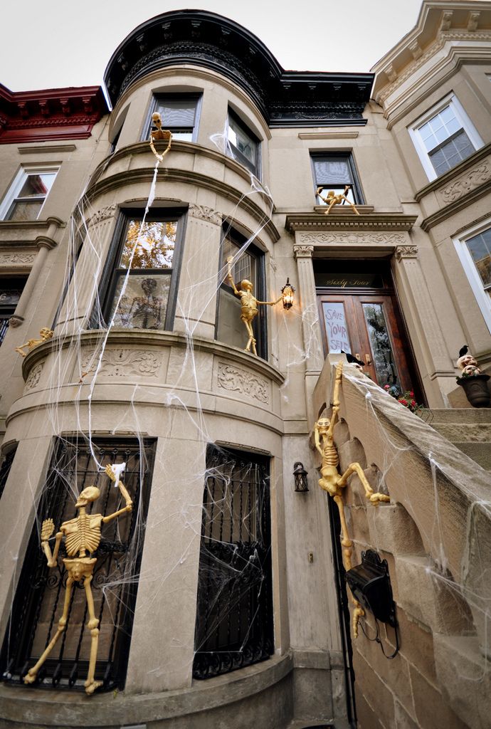 Halloween Skeletons Climbing On House