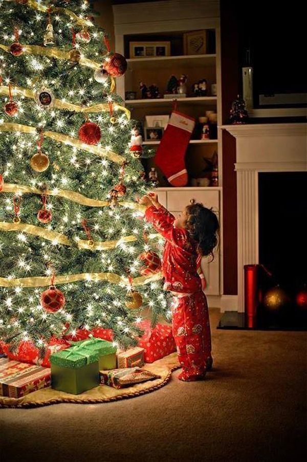 child-decorating-christmas-tree